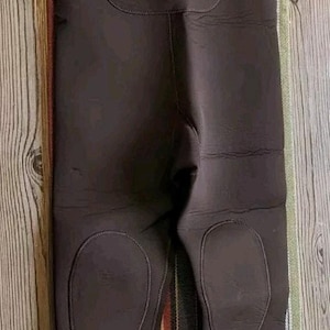 May include: Brown waders with black adjustable straps and a blue and red logo that says "PRO LINE".
