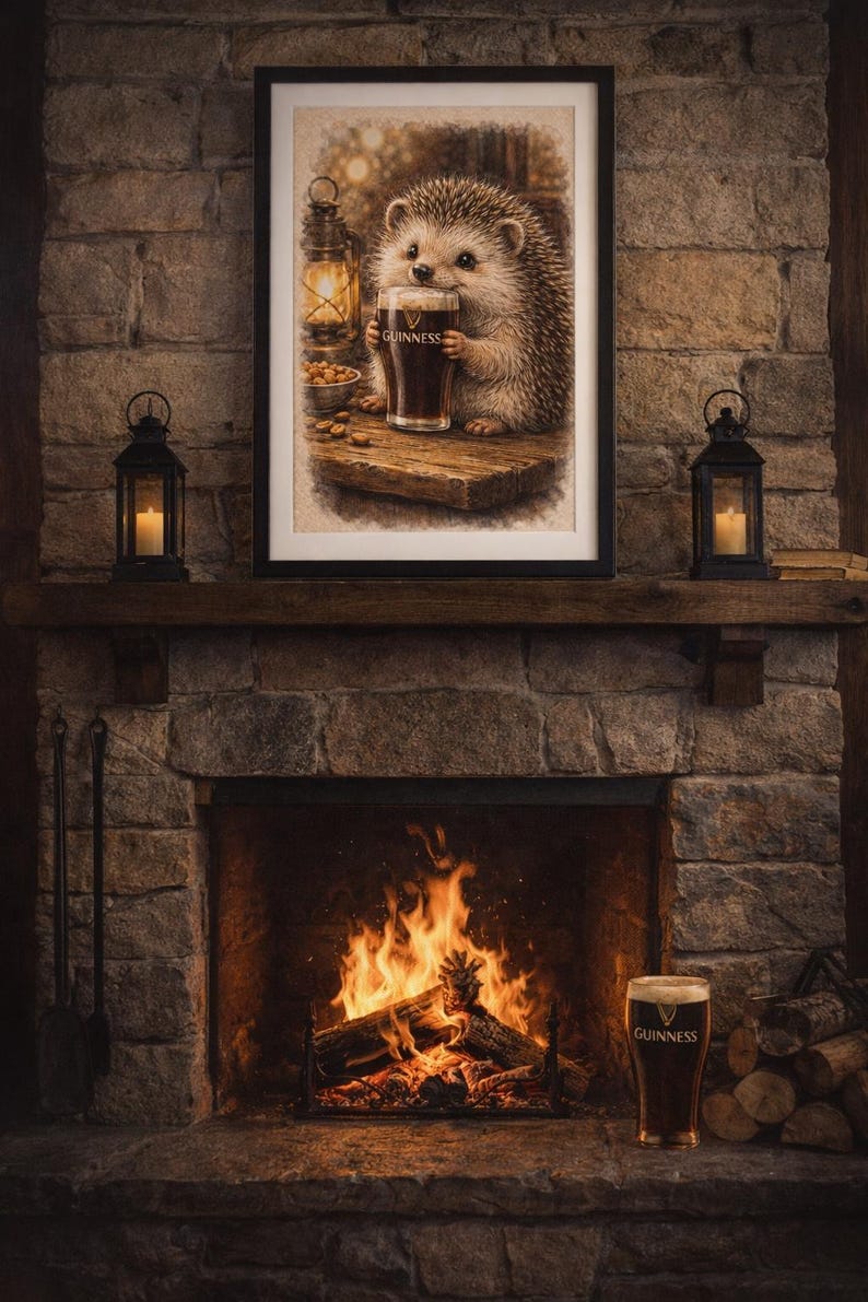 May include: A framed print depicts a hedgehog holding a pint of Guinness, set above a fireplace with a burning fire. The scene includes a lantern, nuts, and a pint of Guinness on the hearth. The image has a warm, inviting atmosphere.