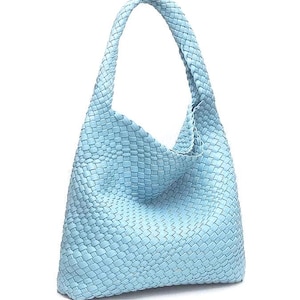 May include: A light blue woven leather shoulder bag with a single handle. The bag has a soft, slouchy shape and a woven texture. The handle is also woven and appears to be sturdy.