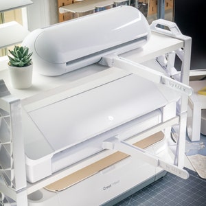 May include: A set of three ceramic mugs with a speckled, matte finish. The mugs are in shades of cream, light gray, and dark gray. Each mug has a simple, minimalist design, perfect for coffee or tea.