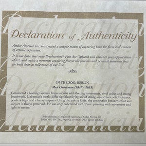 May include: A Declaration of Authenticity certificate with text about Atelier America Inc. and Max Liebermann's painting "In the Zoo, Berlin." The certificate has a beige background with decorative text.
