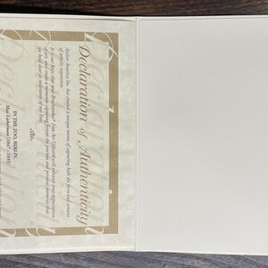 May include: A Declaration of Authenticity document, featuring text in English, with a cream-colored border and a blank white page. The text includes the artist's name, Max Liebermann, and the location, In the Zoo, Berlin.