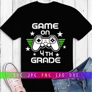 May include: Black t-shirt with a white video game controller graphic and the text "Game On 4th Grade" in green.