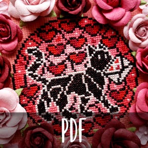 Può includere: Schema di punto croce con un gatto nero con cuori rossi su uno sfondo rosa. Lo schema è circondato da rose rosa e rosse. Il testo "PDF" è stampato sotto lo schema.