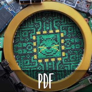 May include: A cross-stitch design in a gold hoop, featuring a green and black geometric pattern with yellow accents. The word "PDF" is overlaid on the image. The background includes various computer circuit boards and components.