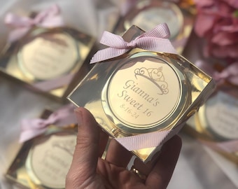 May include: Gold compact mirror with a pink ribbon and a personalized inscription that reads "Gianna's Sweet 16 8-16-24".