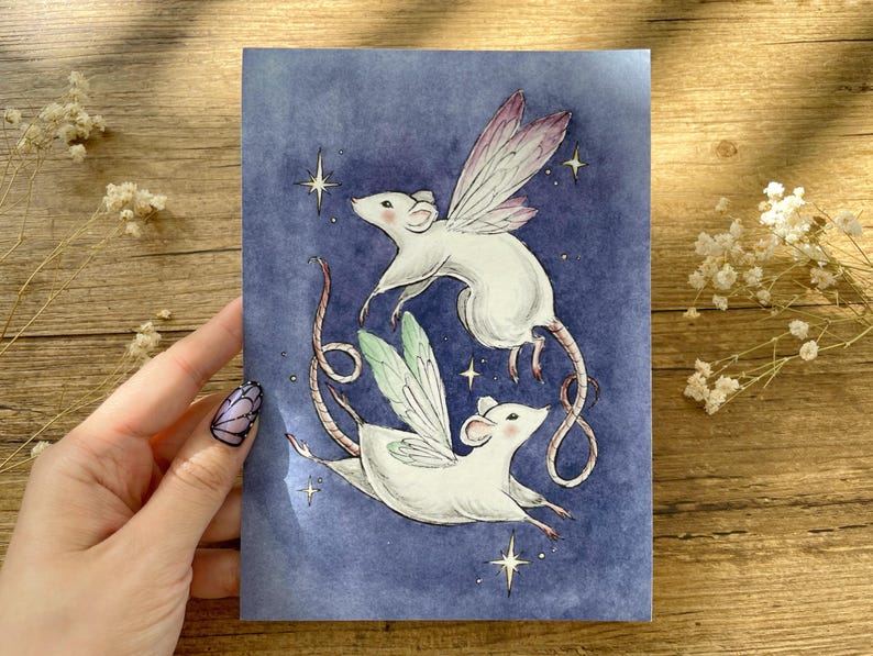 May include: A whimsical illustration of two white mice with fairy wings, set against a deep blue background with sparkling stars. The mice are depicted in mid-flight, with delicate wings in shades of pink and green. The artwork has a dreamy, fairytale aesthetic.