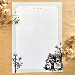 May include: A printable memo pad design featuring a black and white illustration of a cottage with a thatched roof and a small garden. The text "memo" is written at the top of the page.