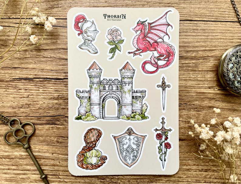 May include: A sheet of stickers featuring a medieval castle, a knight's helmet, a red dragon, a sword, a shield, and a rose. The stickers are printed on white paper with a light brown background.
