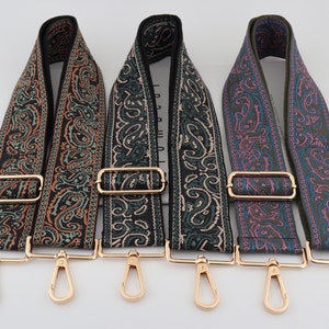 May include: Three adjustable straps with paisley patterns in black, green, and pink with gold-coloured hardware.