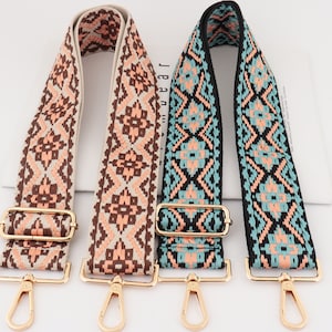 May include: Three adjustable woven fabric straps with gold metal hardware. The straps feature a geometric pattern in shades of brown, pink, and blue.