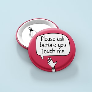 May include: Red button with a white speech bubble that says "Please ask before you touch me". A white hand with five fingers is drawn inside the speech bubble.