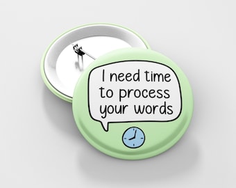 May include: A light green button with a white speech bubble that says "I need time to process your words". A blue clock face with black hands is below the speech bubble.