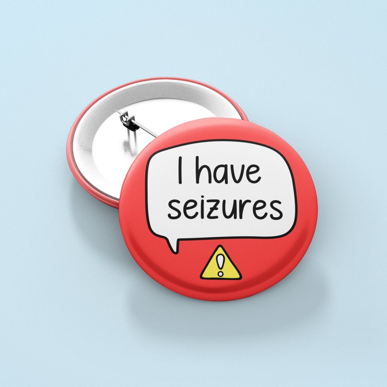 May include: Red button with a white speech bubble that says "I have seizures" and a yellow warning sign with an exclamation point.