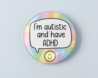 May include: A circular pin-back button featuring a pastel rainbow sunburst background. In the center, a white speech bubble contains the black text 'I'm autistic and have ADHD'. Below the speech bubble is a small, yellow, smiling face icon.