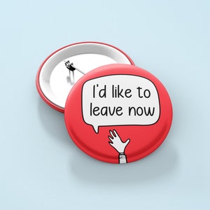 May include: Two red round buttons with a pin back. One button has the text "I'd like to leave now" in a white speech bubble with a cartoon hand. The other button is plain.