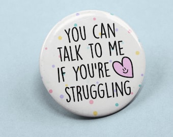 May include: White button with colorful confetti and the text "You can talk to me if you're struggling" with a pink heart with a smiley face.