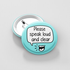May include: A light blue button with a white speech bubble that says "Please speak loud and clear". A cartoon mouth with a tongue sticking out is below the speech bubble.