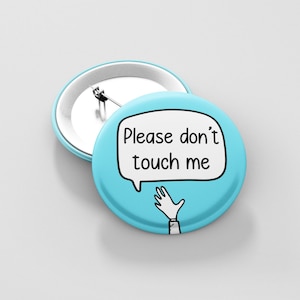 May include: A blue button with a white speech bubble that says "Please don't touch me". A cartoon hand is drawn reaching out from the speech bubble.