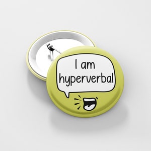 May include: A yellow button with a white speech bubble that says "I am hyperverbal" and a cartoon mouth with a tongue sticking out.