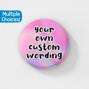 May include: Pink button with a holographic effect and the text "your own custom wording" in black.