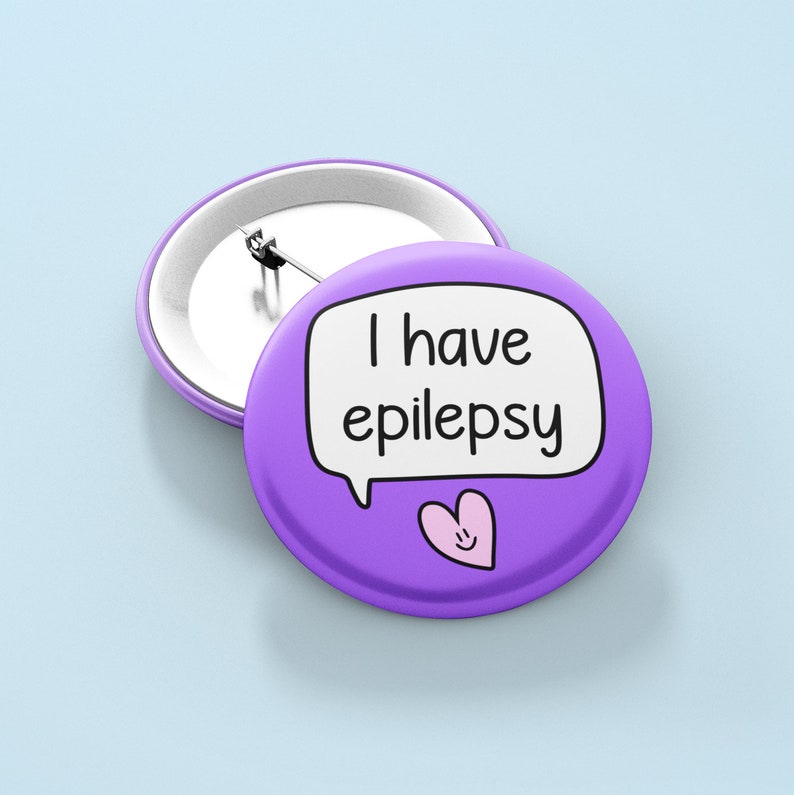 May include: Purple button with a white speech bubble that says "I have epilepsy" and a pink heart with a smiley face.