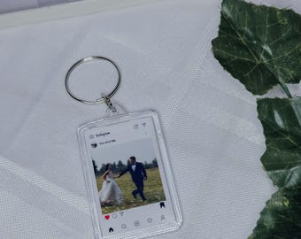 May include: Clear acrylic keychain with a silver keyring. The keychain features a small image of a couple on their wedding day, designed to look like an Instagram post. The text "You And Me" is visible on the image.