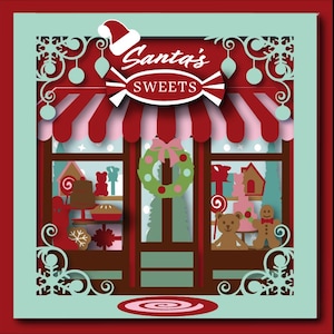 May include: A red and white striped awning with the text "Santa's Sweets" above a storefront window display. The window is decorated with a wreath, candy canes, gingerbread houses, and teddy bears.