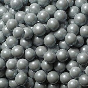 May include: A close-up shot of a pile of gray, spherical objects. The spheres are smooth and have a glossy finish, reflecting light. The objects are densely packed together, filling the frame.