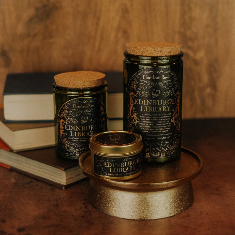 Side by side shot of the three sizes of Edinburgh Library soy candles – 15 oz jar, 11 oz jar, and 3.3 oz gold tin