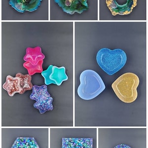May include: Assortment of resin trinket dishes in various shapes and colors, including stars, hearts, and circles. Some dishes have glitter embedded in the resin, while others have a smooth finish. The dishes are perfect for holding small items like jewelry, keys, or coins.