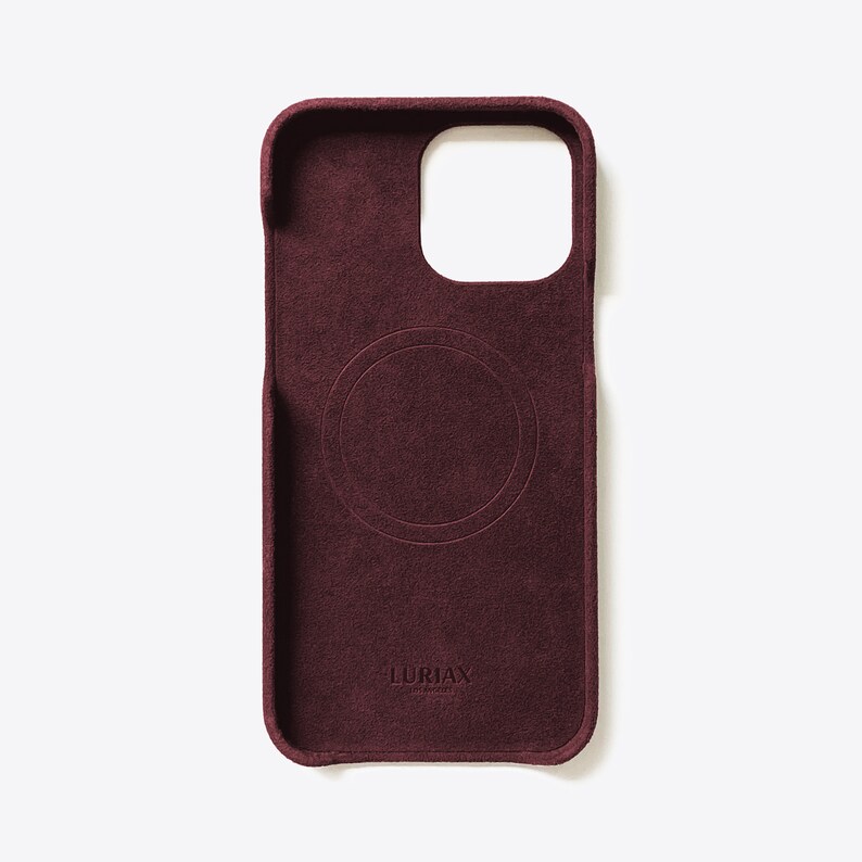 May include: A burgundy phone case with a circular cutout for wireless charging and the text "LURIAX" in white.