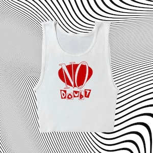 May include: White tank top with a red oval containing the word "NO" in white letters and the word "DOUBT" in white letters below the oval.