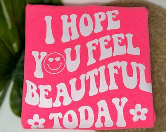 Sudadera rosa con cuello redondo y mensaje positivo: Espero que te sientas hermosa.