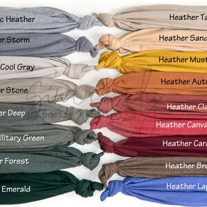 May include: A display of various heather-colored fabric swatches, each knotted at the end. The colors include Athletic Heather, Heather Storm, Heather Tan, Heather Sand Dune, Heather Mustard, Heather Autumn, Heather Cool Gray, Heather Stone, Heather Deep, Heather Military Green, Heather Forest, Heather Emerald, Heather Clay, Heather Canvas Red, Heather Cardinal, Heather Brown, and Heather Lapis.