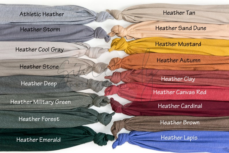 May include: A display of various heather-colored fabric swatches, each knotted at the end. The colors include Athletic Heather, Heather Storm, Heather Tan, Heather Sand Dune, Heather Mustard, Heather Autumn, Heather Cool Gray, Heather Stone, Heather Deep, Heather Military Green, Heather Forest, Heather Emerald, Heather Clay, Heather Canvas Red, Heather Cardinal, Heather Brown, and Heather Lapis.