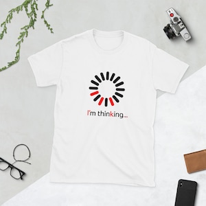 May include: White t-shirt with a black and red loading icon and the text "I'm thinking..."