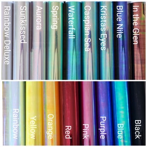 May include: A collection of 14 iridescent vinyl sheets in various colors, including rainbow, blue, green, purple, pink, red, orange, yellow, and black. The vinyl sheets are labeled with names like "Rainbow Deluxe", "Sunkissed", "Aurora", "Spring", "Waterfall", "Caspian Sea", "Kristas Eyes", "Blue Nile", "In the Glen", "Black", "Blue", "Purple", "Pink", "Red", "Orange", "Yellow", and "Rainbow".