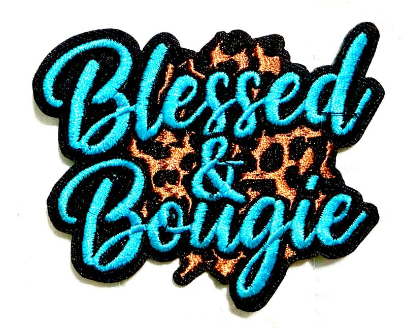May include: Embroidered patch with the words "Blessed & Bougie" in turquoise script. The text is outlined in black and set against a leopard print background. The patch has a black border.