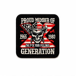 May include: A black square patch with white text and a skull wearing a cowboy hat. The patch reads "PROUD MEMBER OF" above the skull, and "THE F*CK YOUR FEELINGS GENERATION" below. The years 1965 and 1980 are also displayed.