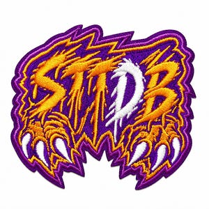 May include: An embroidered patch featuring the letters STDB in a jagged, dripping font. The letters are primarily orange with a white D, set against a purple background. The design includes sharp, claw-like shapes at the bottom with white tips.
