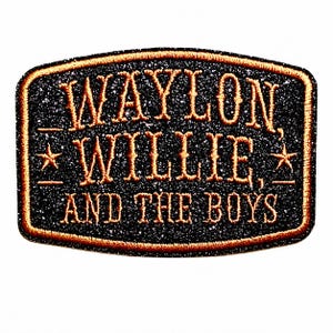 May include: A rectangular embroidered patch with rounded corners featuring a black glittery background and a copper-colored border. The text reads WAYLON, WILLIE, AND THE BOYS in copper-colored lettering, with a small star on each side of the middle line.