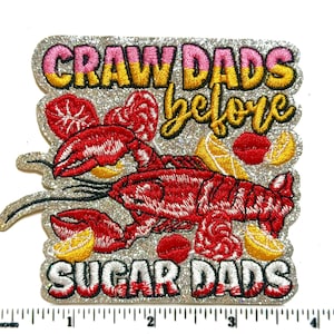 May include: A white ceramic mug with a black handle and the text "But First, Coffee" in a black, handwritten-style font. The mug is on a white surface.