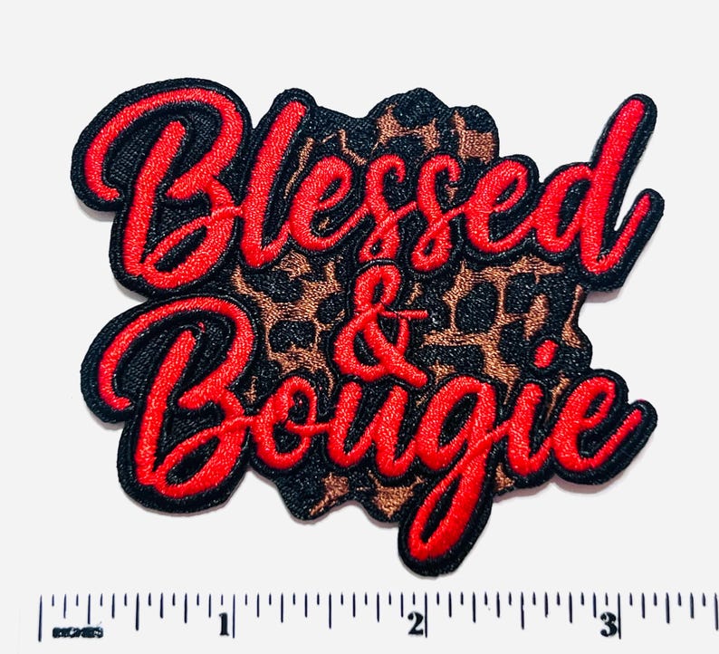 May include: Embroidered patch with the words "Blessed & Bougie" in red script lettering. The text is outlined in black and set against a leopard print background. The patch measures approximately 3 inches wide.