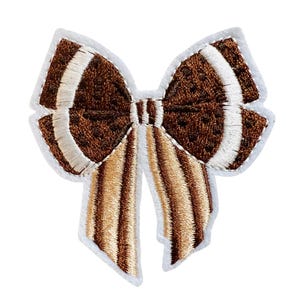 May include: A brown and white embroidered bow with a striped ribbon. The bow is on a white background.