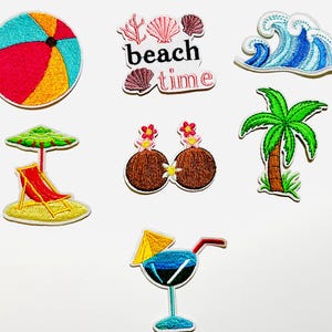 May include: A collection of embroidered patches featuring beach-themed designs. Includes a colorful beach ball, a wave, a palm tree, a cocktail, a beach chair under an umbrella, coconuts with flowers, and the text "beach time."