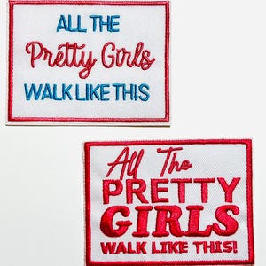 May include: Two embroidered patches with the text "ALL THE Pretty Girls WALK LIKE THIS" in red and blue on a white background, framed by a red border. The second patch has the same text in red.
