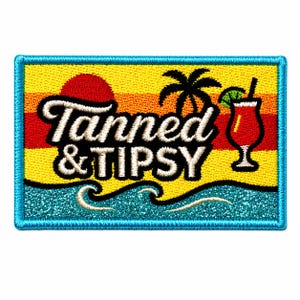May include: A rectangular embroidered patch with a bright blue border. The design features a yellow and orange sunset, a black palm tree silhouette, a red cocktail glass with a lime wedge, and the white text TANNED & TIPSY above blue ocean waves.