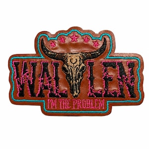 May include: A brown leather patch featuring an embroidered black bull skull centered between the letters WAL and LEN. The text I'M THE PROBLEM is stitched in pink below the skull, with five pink stars above it, all outlined in bright turquoise.