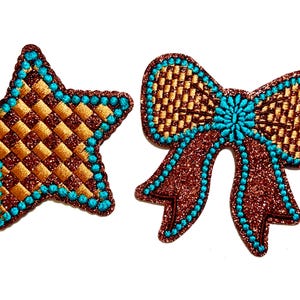 May include: Two decorative patches: a star and a bow. The star has a brown and gold checkered pattern with a teal border. The bow is brown with a teal center and border, both with glitter.
